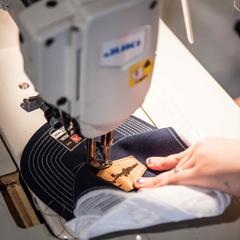 sewing a patch on a hat